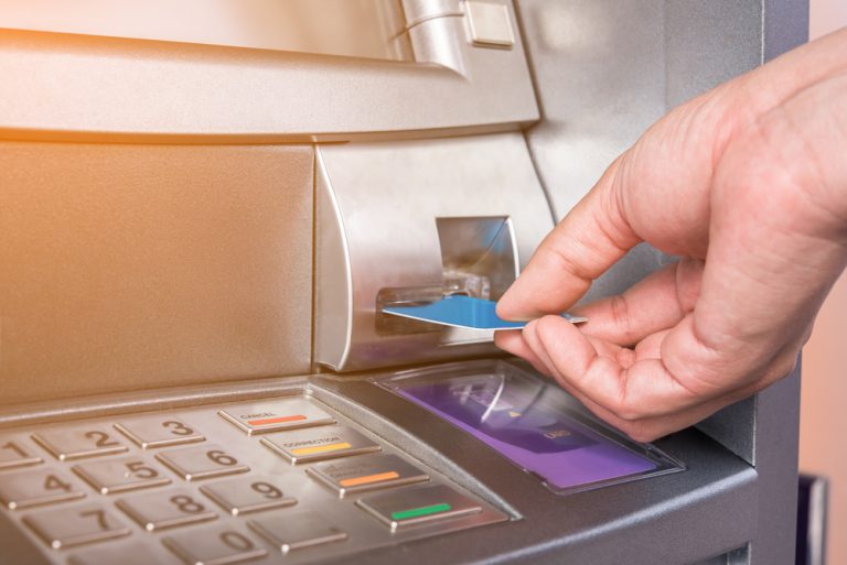 Hand,Inserting,Atm,Card,Into,Bank,Machine,To,Withdraw,Money